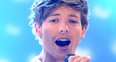 Louis Tomlinson of One Direction on stage