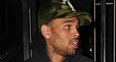 Chris Brown pictured leaving Rihanna's hotel