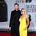  Rita Ora and Calvin Harris pose for pictures together on the red carpet.